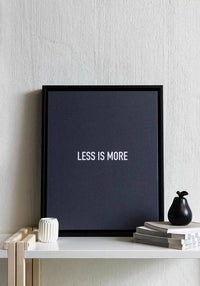 Custom framed canvas print with the phrase 'Less is More' in minimalistic black and white decor.