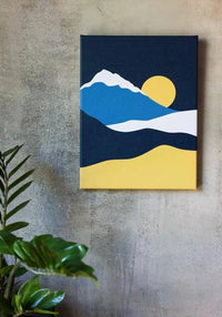 Custom printed canvas art featuring a minimalist mountain scene and sun against a textured wall.